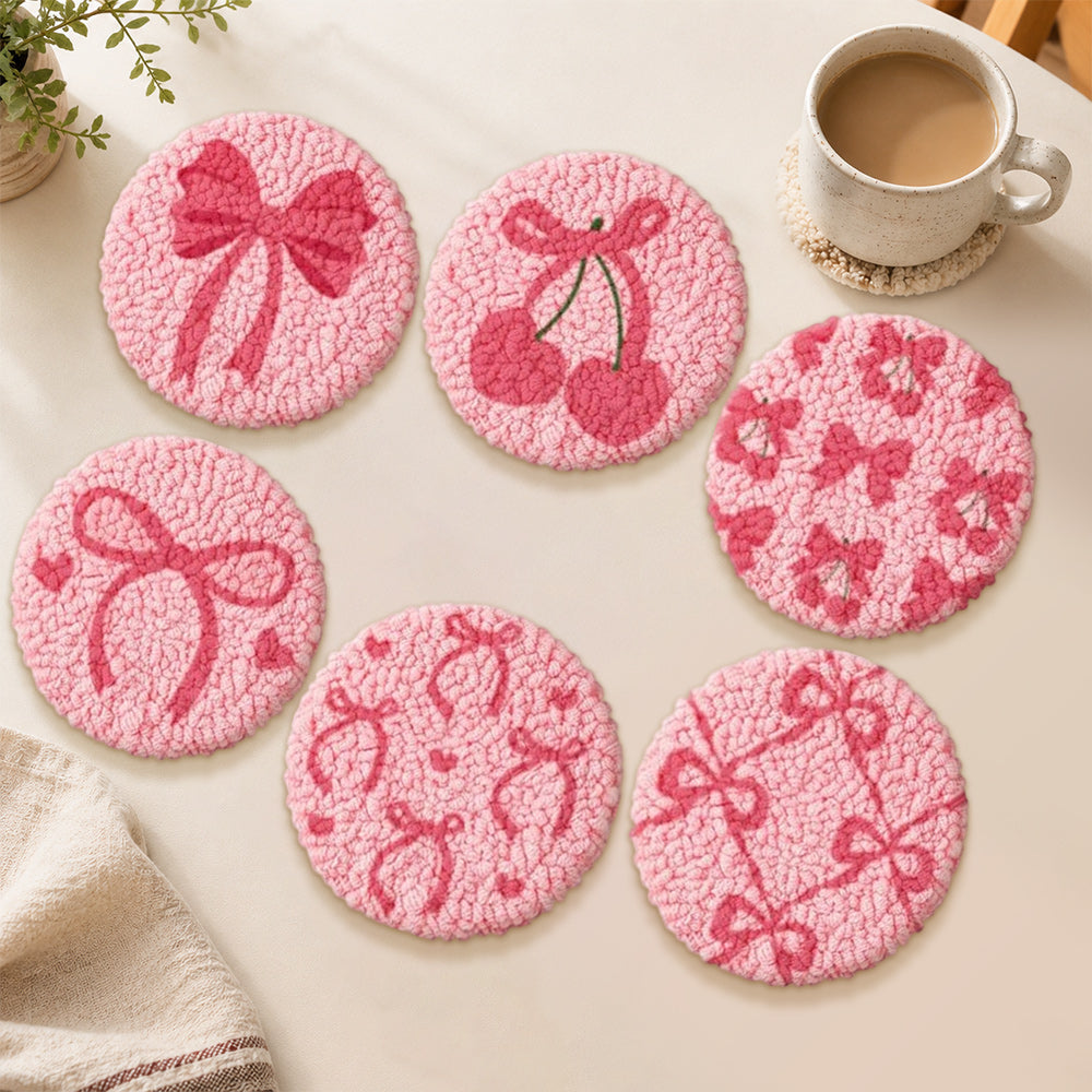 Pink bow and cherry punch needle coasters used for home decoration