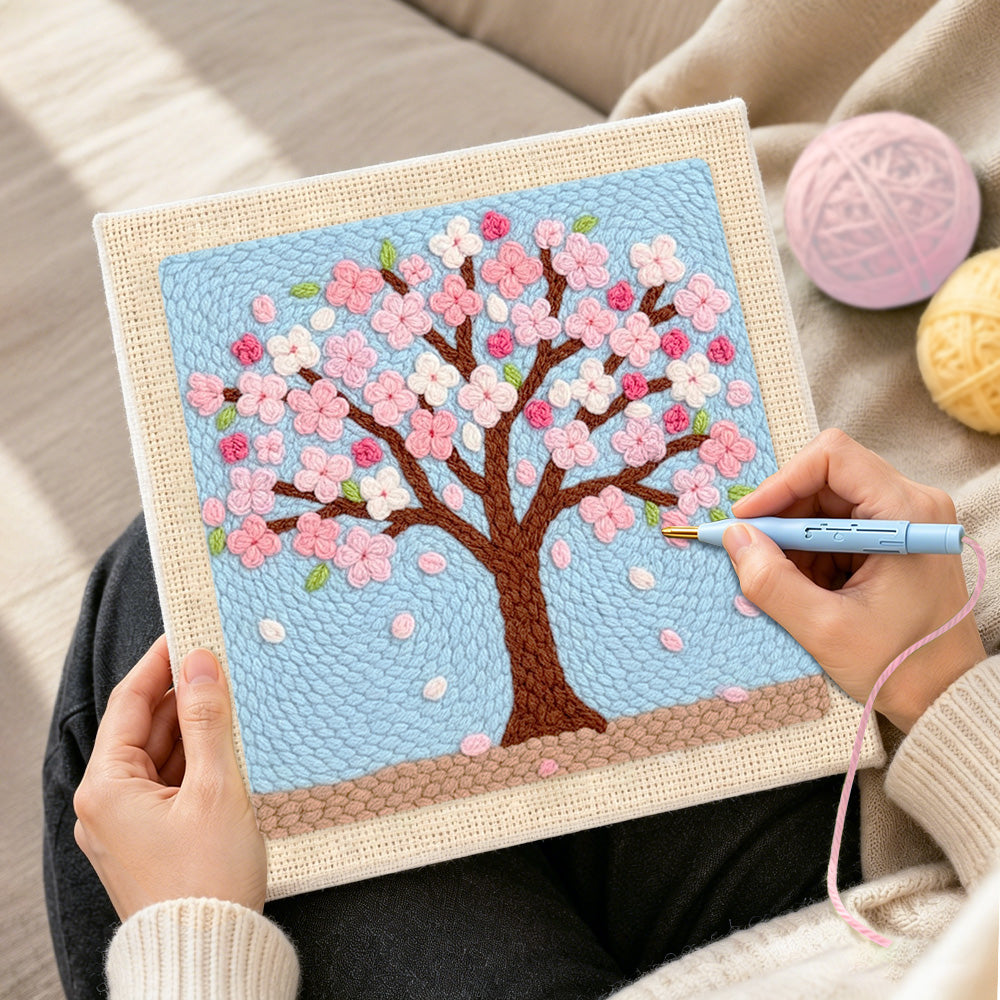 Creating handmade pink cherry blossom tree punch needle artwork