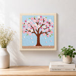 Finished pink cherry blossom tree artwork displayed on a wall