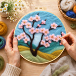 Creating the pink cherry tree on hills wool painting by hand with a felting needle
