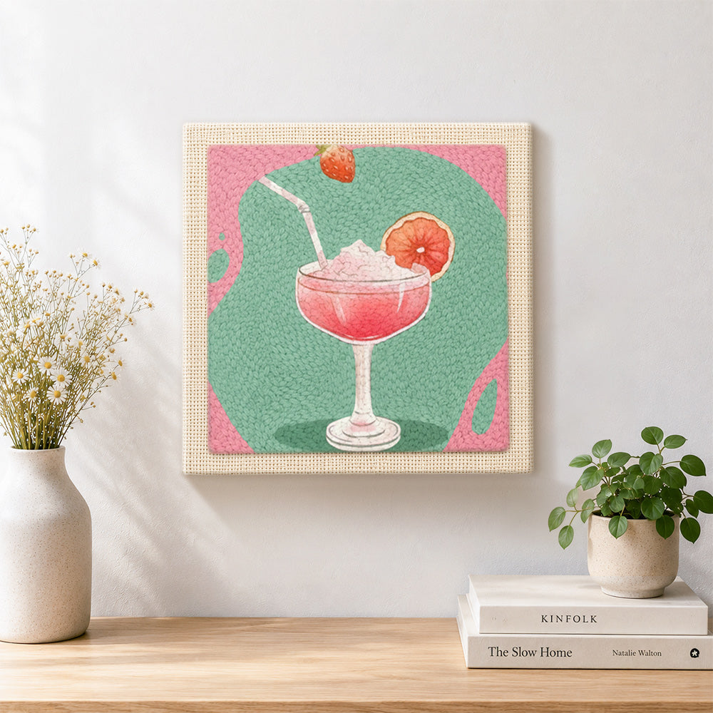 Finished pink cocktail with grapefruit artwork displayed on a wall