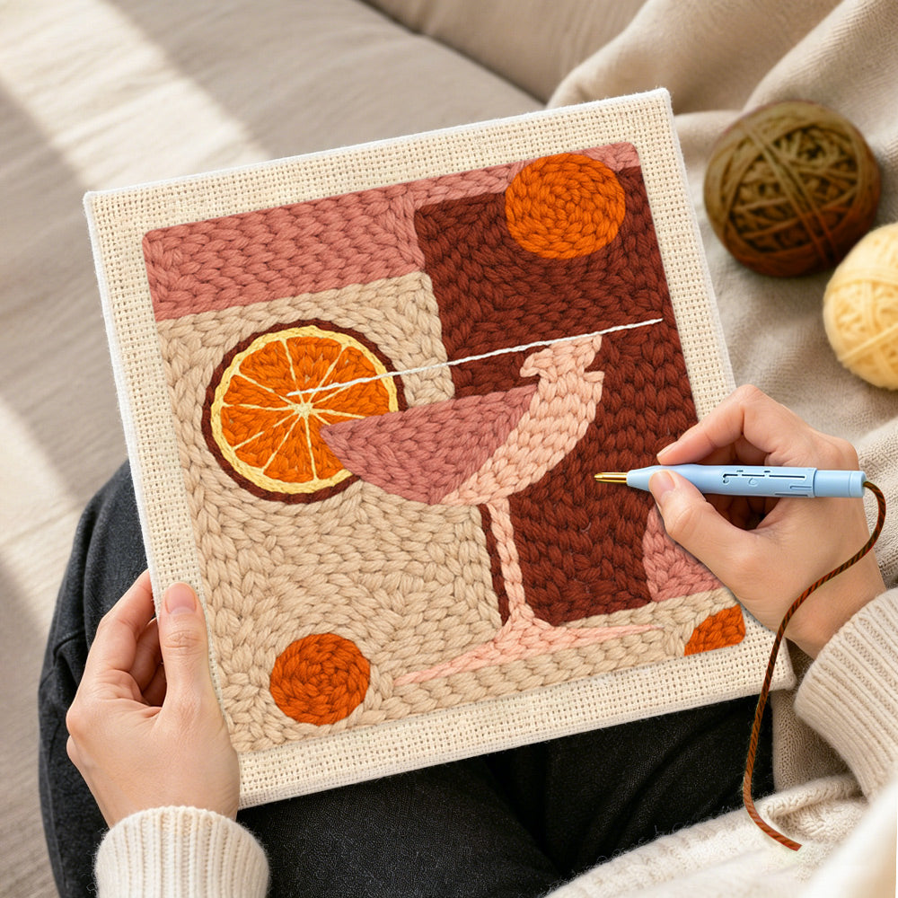 Creating handmade pink drink with large orange slice punch needle artwork