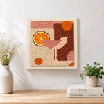 Finished pink drink with large orange slice artwork displayed on a wall