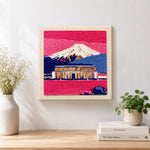Finished pink dusk temple and snowy mountain artwork displayed on a wall