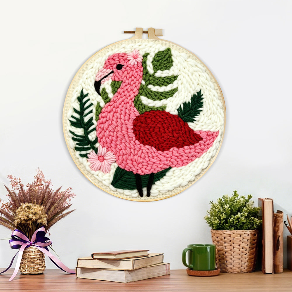 Finished pink flamingo and green plants artwork displayed on a wall