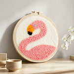 Pink flamingo punch needle artwork displayed on a table