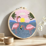 Pink flamingos by the sea punch needle artwork displayed on a table