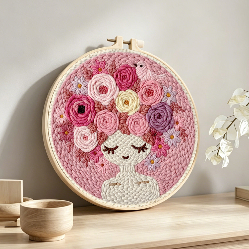 Pink floral crown girl punch needle artwork displayed on a table