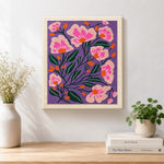 Finished pink florals on deep purple background artwork displayed on a wall