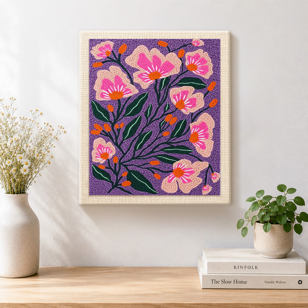 Finished pink florals on deep purple background artwork displayed on a wall