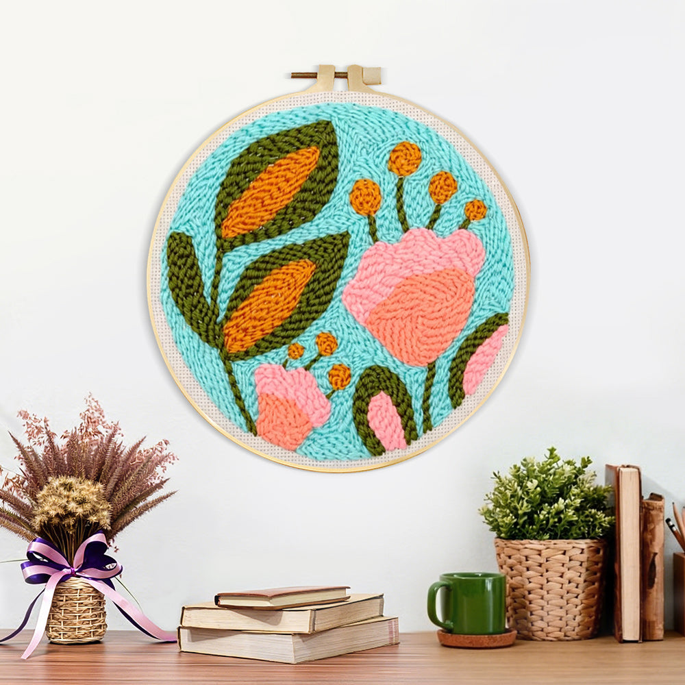 Finished pink flower and green leaves artwork displayed on a wall