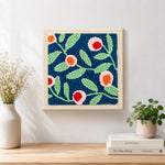 Finished pink flowers with green leaves artwork displayed on a wall