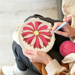 Creating handmade pink geometric sunburst flower punch needle artwork