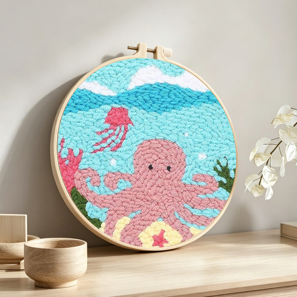 Pink octopus punch needle artwork displayed on a table