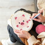 Creating handmade pink piglet punch needle artwork