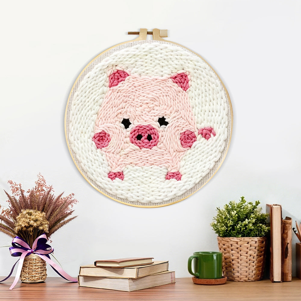 Finished pink piglet artwork displayed on a wall