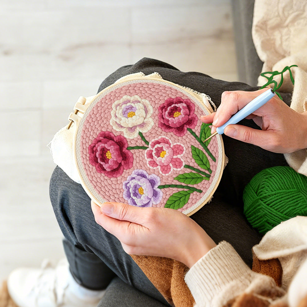 Creating handmade pink, purple and white layered flowers punch needle artwork