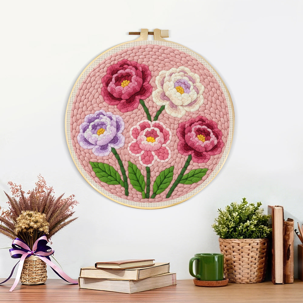 Finished pink, purple and white layered flowers artwork displayed on a wall