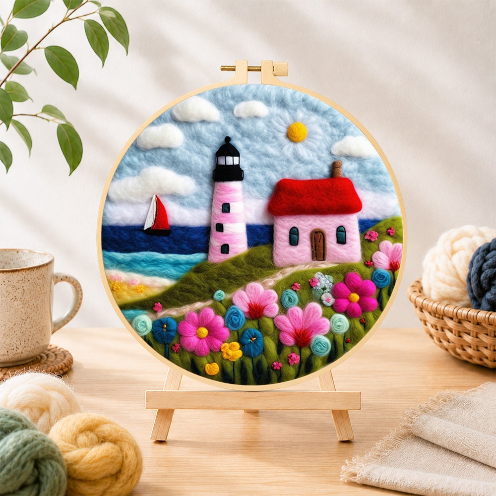 Finished pink striped lighthouse and flowers needle felting displayed on a wooden easel