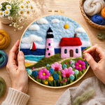 Creating the pink striped lighthouse and flowers wool painting by hand with a felting needle