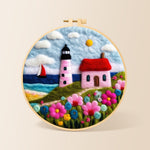 Pink striped lighthouse and flowers needle felting kit for beginners with a round wooden frame