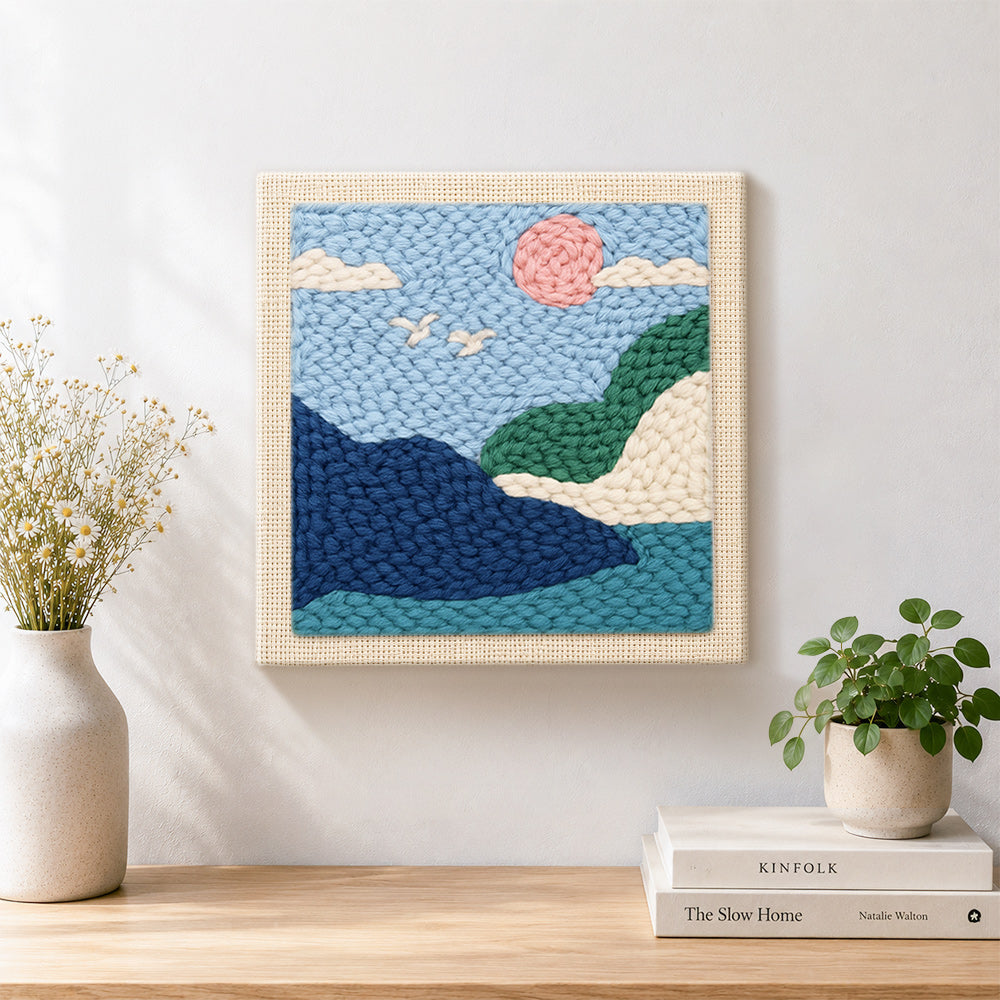 Finished pink sun and green hills artwork displayed on a wall