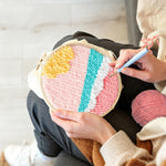 Creating handmade pink toned sea waves punch needle artwork