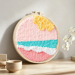 Pink toned sea waves punch needle artwork displayed on a table