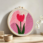 Pink tulip punch needle artwork displayed on a table