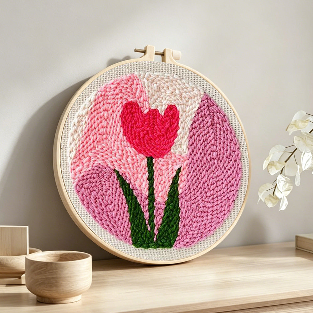 Pink tulip punch needle artwork displayed on a table