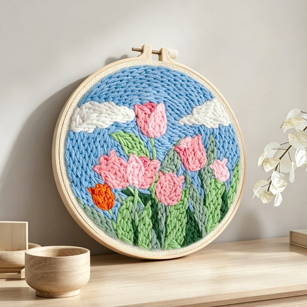 Pink tulips under the blue sky punch needle artwork displayed on a table