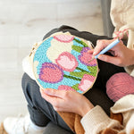 Creating handmade pink tulips under the sky and clouds punch needle artwork
