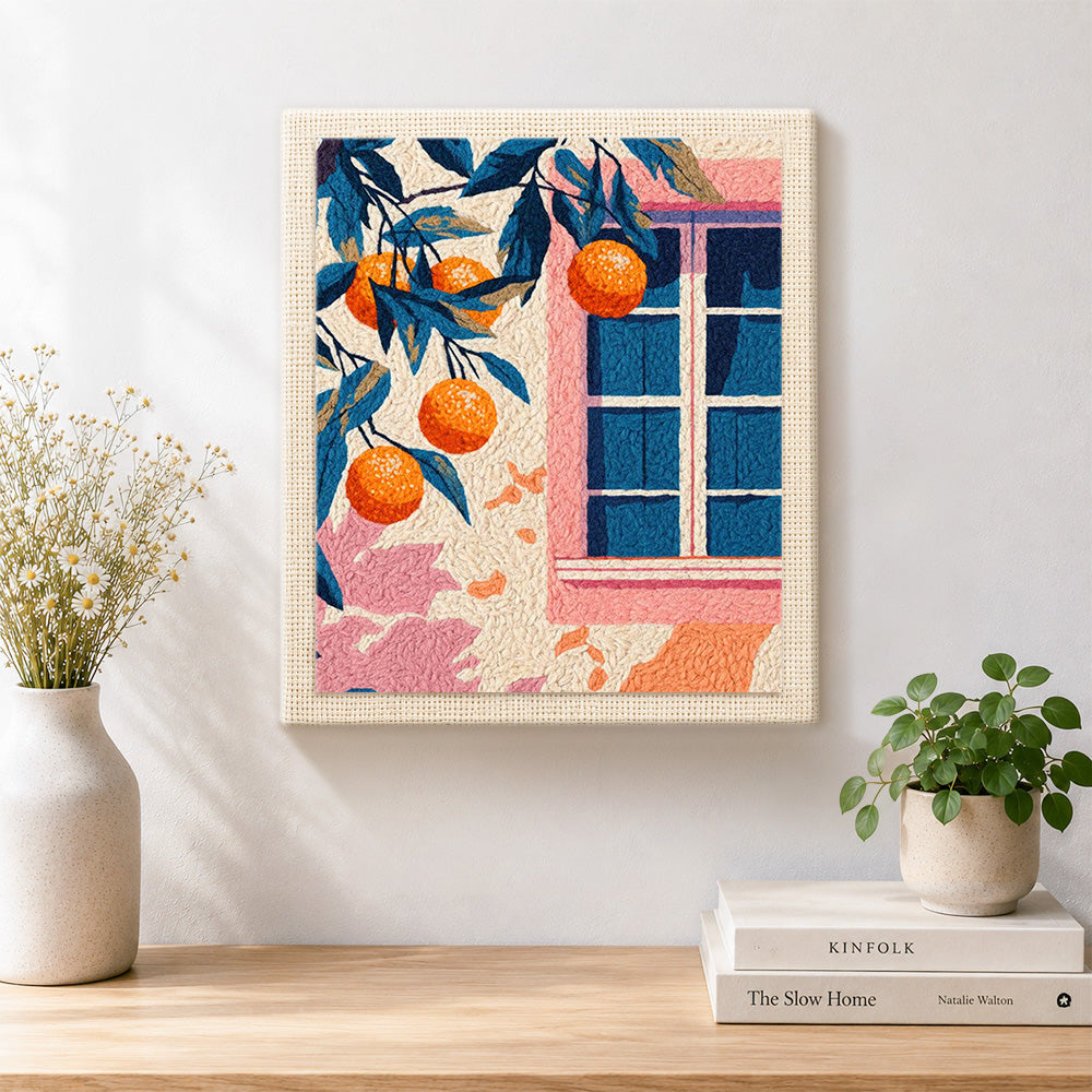 Finished pink window and orange tree artwork displayed on a wall
