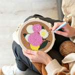 Creating handmade pink, yellow and white balloon cluster punch needle artwork