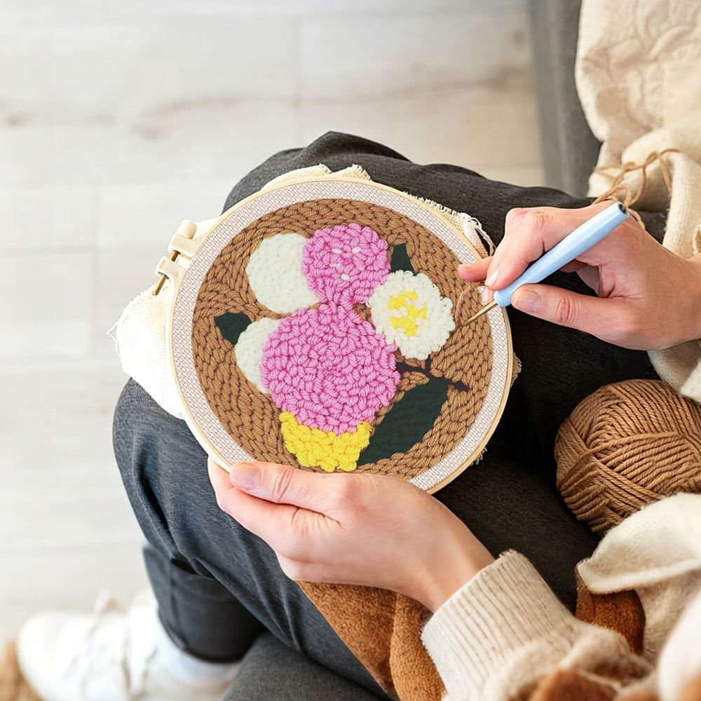Creating handmade pink, yellow and white balloon cluster punch needle artwork