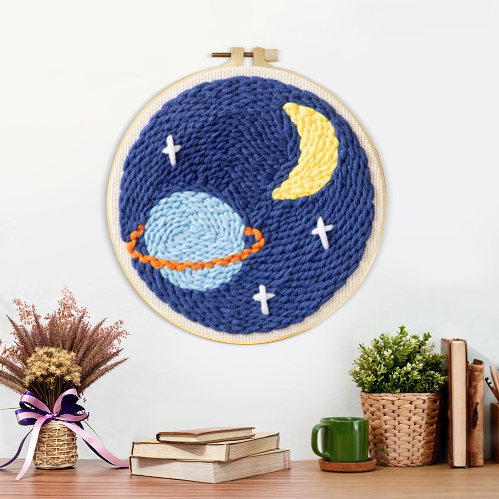 Finished planet, crescent moon and stars artwork displayed on a wall