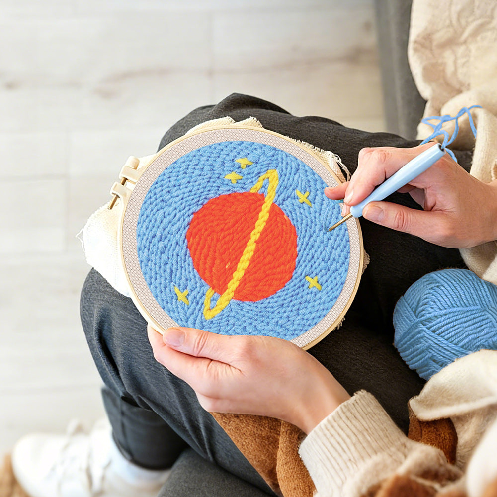 Creating handmade planet with rings and stars punch needle artwork