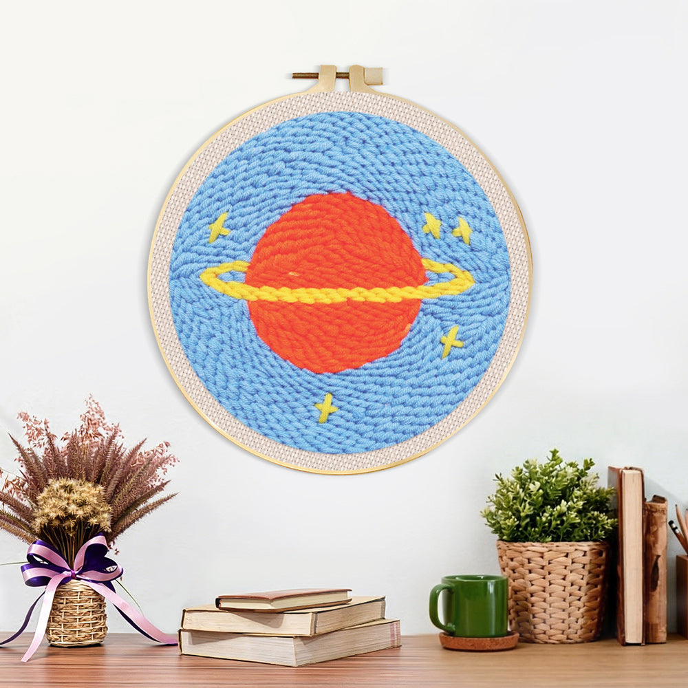 Finished planet with rings and stars artwork displayed on a wall