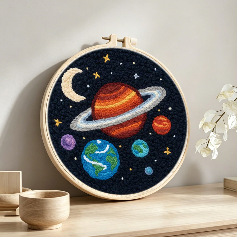 Planets and moon solar system punch needle artwork displayed on a table