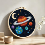 Planets and moon solar system punch needle artwork displayed on a table
