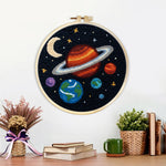 Finished planets and moon solar system artwork displayed on a wall