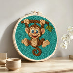 Playful little monkey punch needle artwork displayed on a table