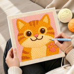 Creating handmade playful orange cat waving paw punch needle artwork