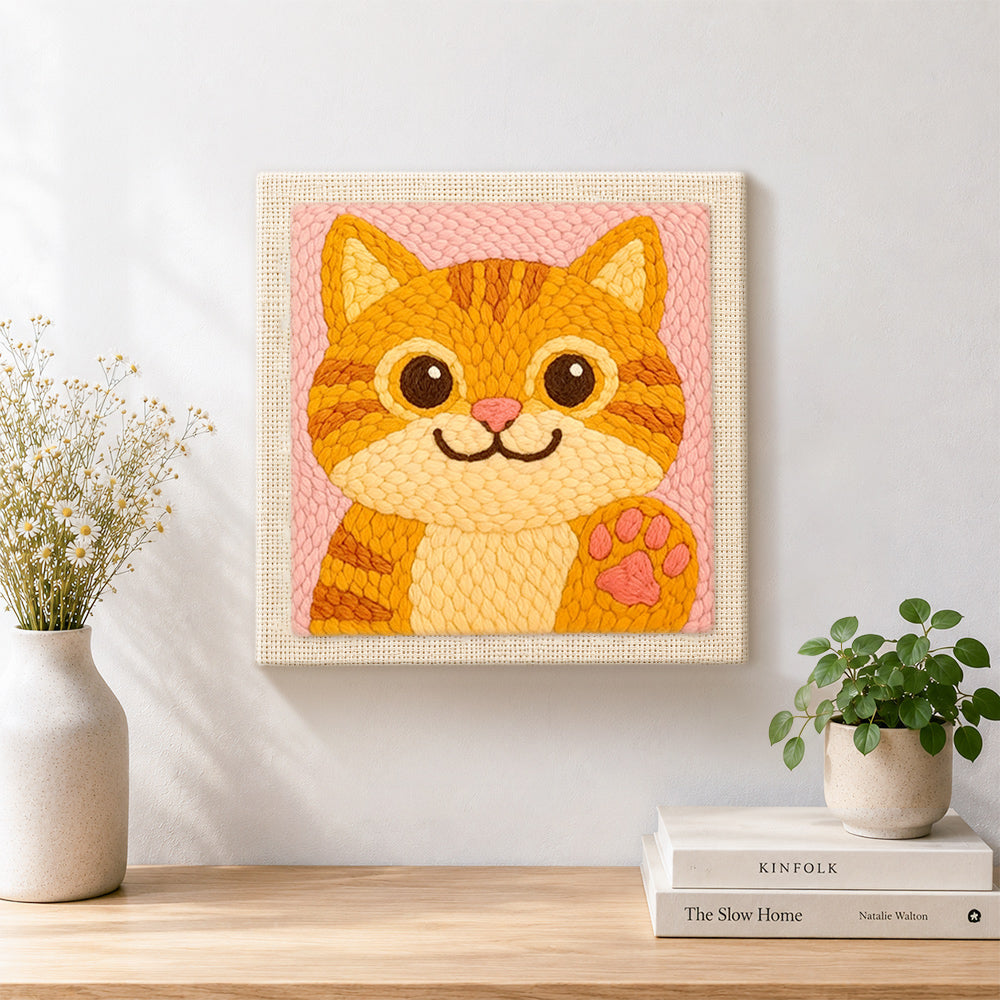 Finished playful orange cat waving paw artwork displayed on a wall
