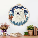 Finished polar bear in mountain forest artwork displayed on a wall