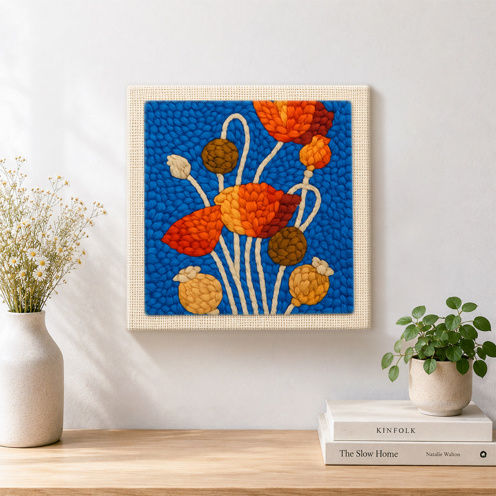 Finished poppy flowers and seeds artwork displayed on a wall