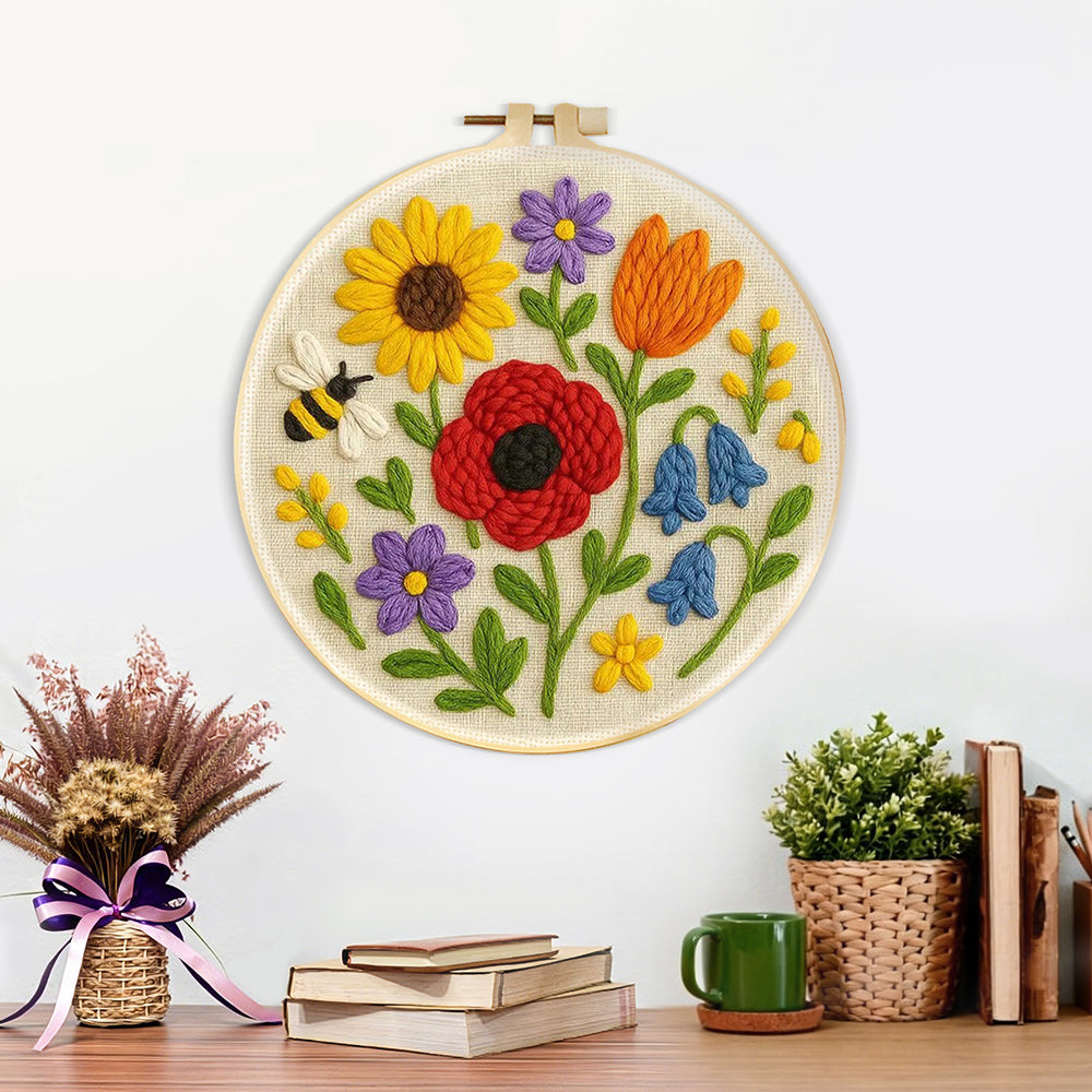 Finished poppy, sunflower and bumblebee artwork displayed on a wall