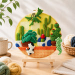 Finished potted cacti of various shapes needle felting displayed on a wooden easel