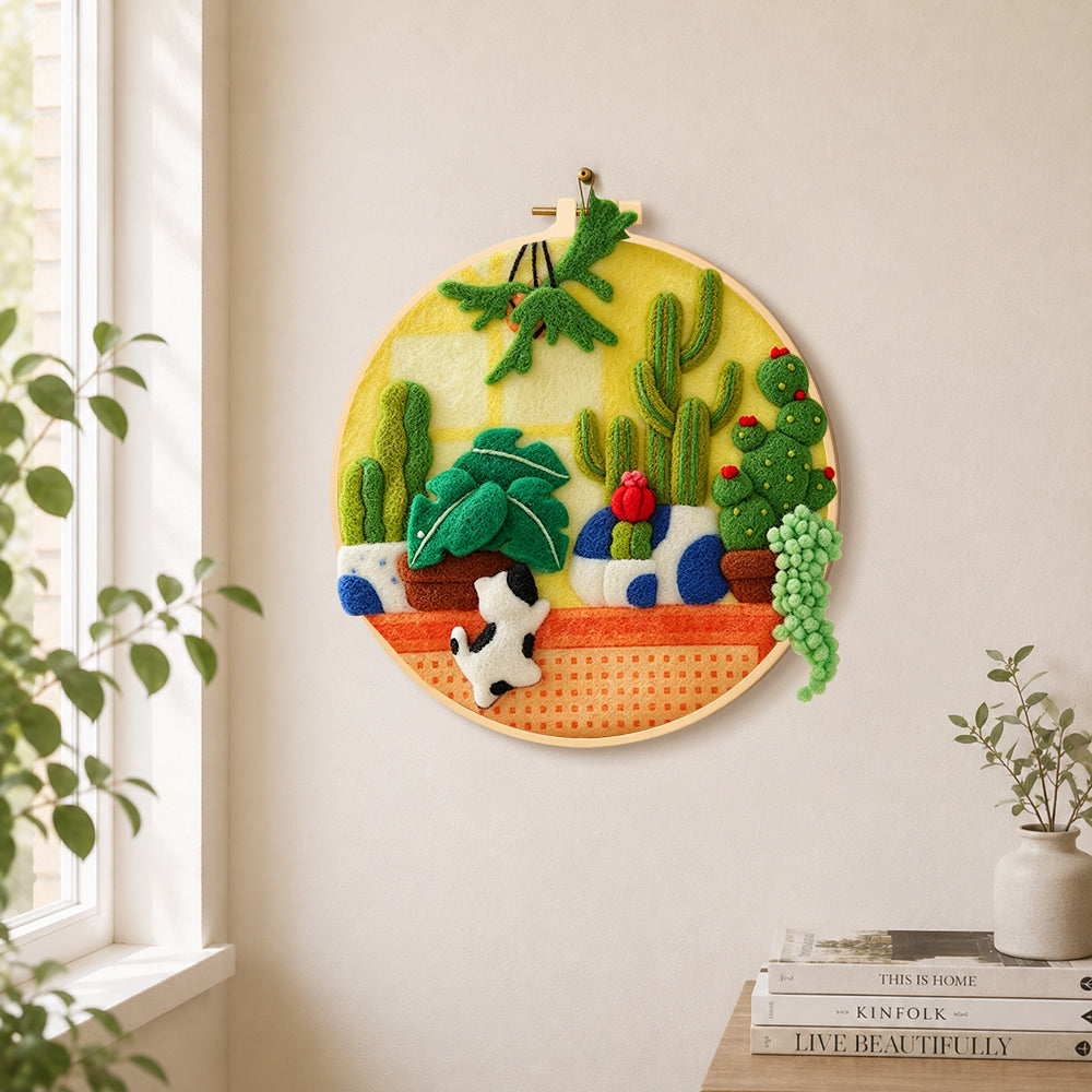 Potted cacti of various shapes needle felt wall art displayed in a bright home interior
