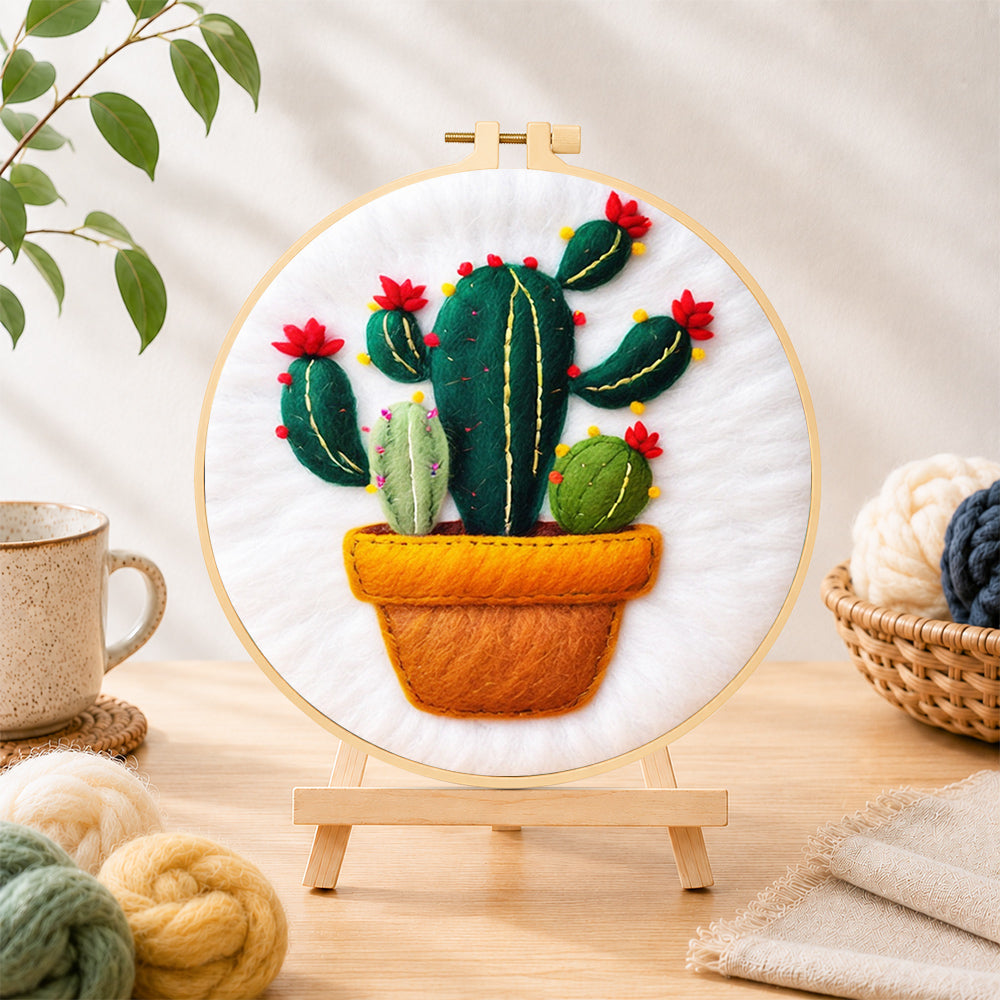 Finished potted cactus with red flowers needle felting displayed on a wooden easel